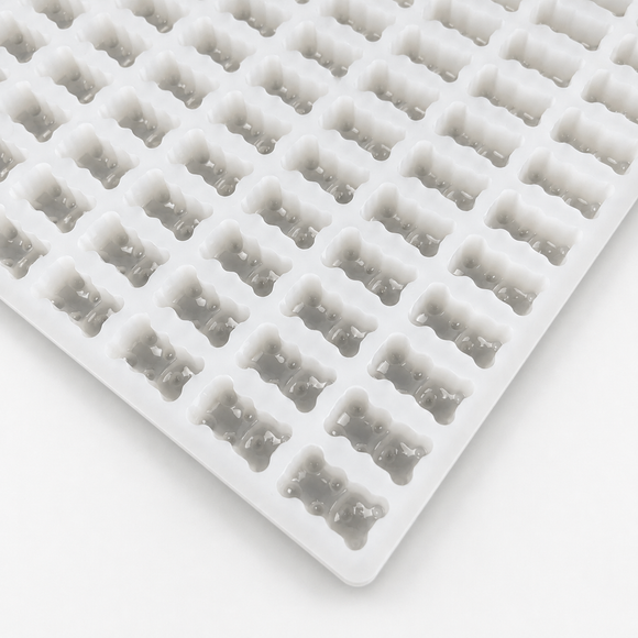 Close-up of a 2.3mL gummy bear silicone mold with 230 cavities on a clean white background