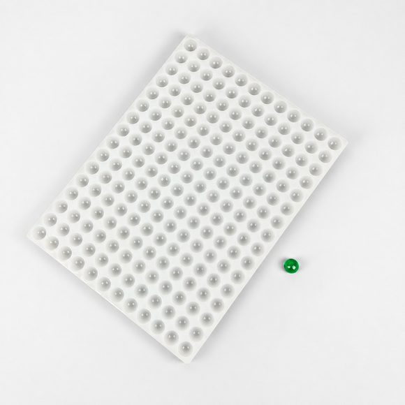 Diagonal view of the 2.8mL half-sphere silicone mold with an emerald green gummy sample