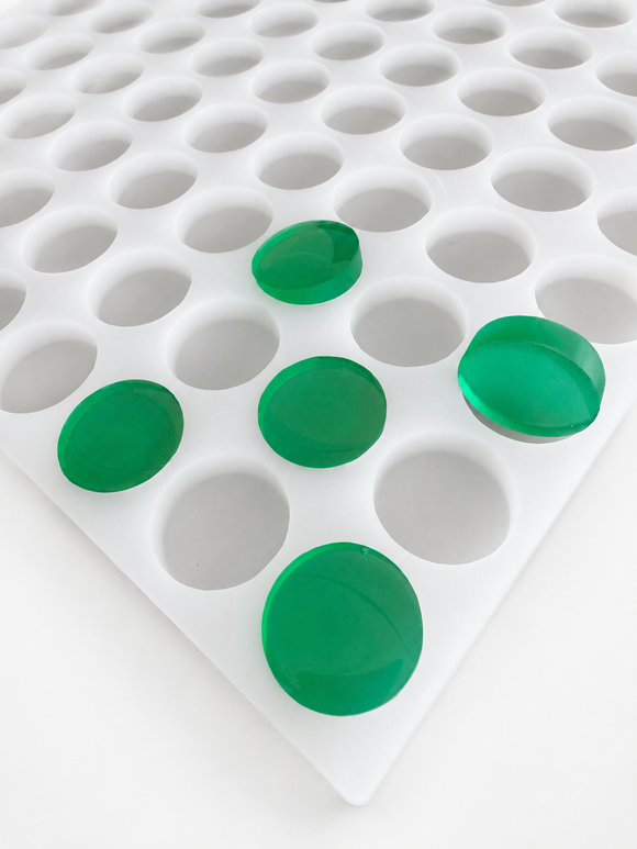 3.8mL coin gummy mold with 130 cavities and emerald green round gummies